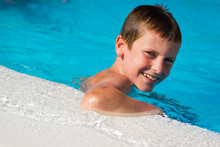 Smiling Boy Portrait On Swimming Pool Edge. Sunscreen, Solar Danger, Ultraviolet Protection, Skin Care, Summer Vacation, Resort Holidays, Leisure Time Concepts