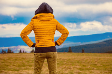 Confident woman looking at the distant landscape.