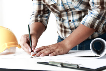 Technician is writing building construction. On the office desk