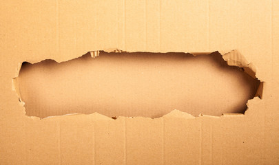 Wall Mural - Cardboard with a hole - black background