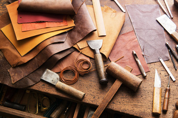 leather craft or leather working. selected pieces of beautifully colored or tanned leather on leathe