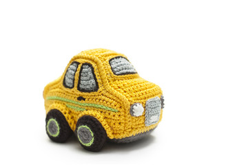 small knitted yellow baby machine on white background