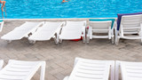Fototapeta  - Beach chairs near swimming pool