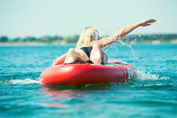 Sticker - Young sexy woman swimming on paddle board.Water sports , active lifestyle.	