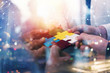 © alphaspirit - Business people join puzzle pieces in office. Concept of teamwork and partnership. double exposure with internet network effects