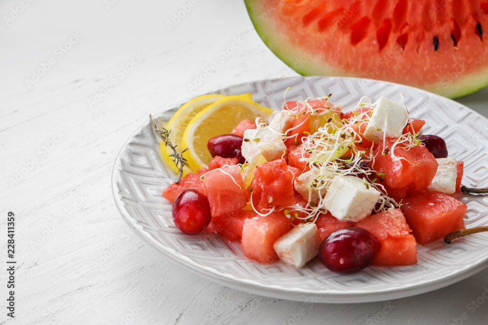 Plate with delicious watermelon salad on white table