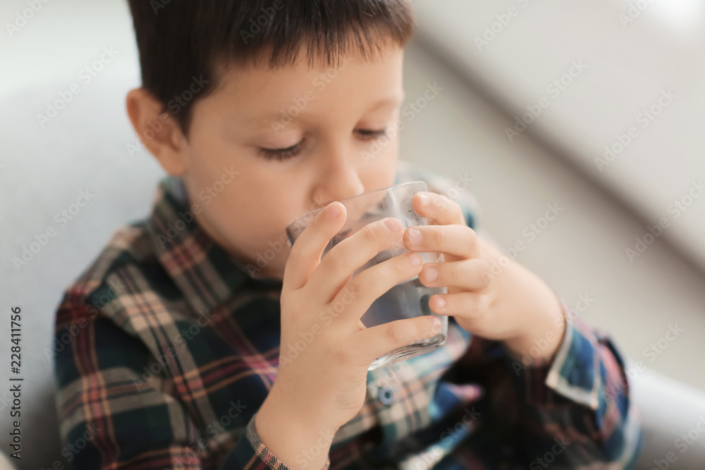 Little boy drinking fresh water