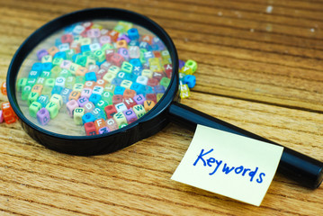 Small dice alphabet and glass magnifier. Search for keyword concept