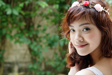 Young pretty Asian woman with flower headband.