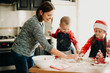 © Strelciuc - Woman with children preparing cookies