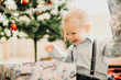 © Strelciuc - Infant boy opening Christmas present