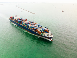 Aerial view of Small container ship at sea freight, Business International trade and Container logistics export-import harbor to the International port / Shipping Containers concept.