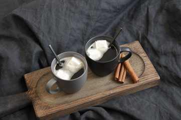 Wall Mural - Two coffee mug in dark grey bed