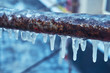 © Александр Коновалов - Many small icicles have frozen on a rusty pipe in the street in the winter