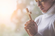 © Tinnakorn - Women pray to God with  the cross of the morning. Woman Pray for god blessing to wishing have a better life. Christian life crisis prayer to god.