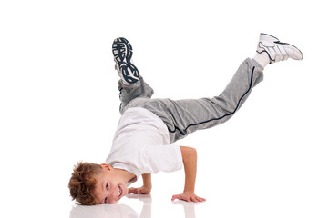 Happy little hip hop dancer - boy dancing isolated on white background. Young white b-boy dancing break dance.