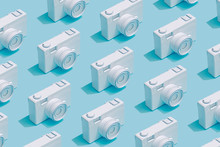 Pattern Composition Of Vintage Cameras On Pastel Blue Background. Minimalist Isometric Concept.