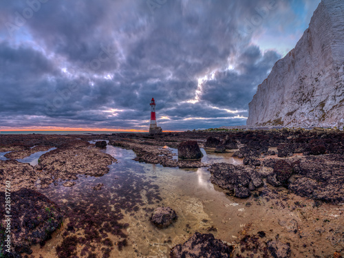 Fotografie, Obraz Beachy Head Lighthouse at sunset into the blue hour - stitched panorama processe