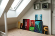 © Forenius - Home interior. Art collection in modern attic / loft apartment. Skylight window.