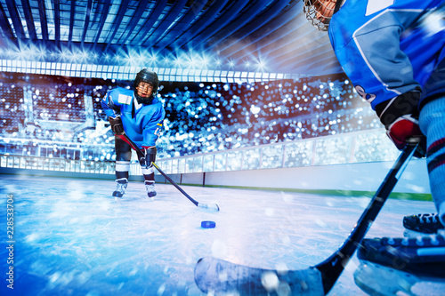 Fototapeta na szkło Ice hockey player passing the puck to teammate