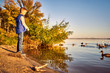 © 6okean - Happy teen feeding ducks in the river