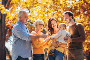 Multl generation family in autumn park having fun