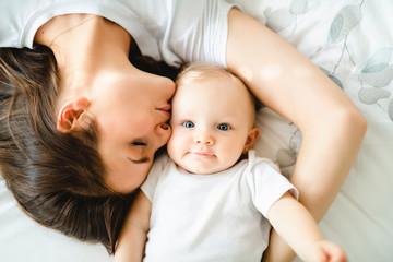 Poster - mother with baby on bed having good time