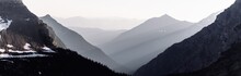 Smoky Mountain Haze From Wildfires With Sun Rays In Glacier National Park