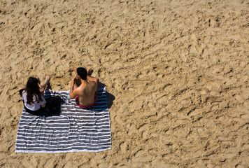 Young couple resting on the beach.