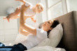 © Louis-Photo - mother with baby on bed having good time