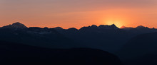 Panorama Of Dramatic Sun Rays As The Sun Sets Behind Heaven's Peak And Livingston Range, In Glacier National Park, Montana