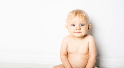 Poster - A six month old baby, sit on the floor