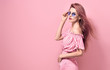 Fashion. Blonde Girl Posing in Studio on Pink