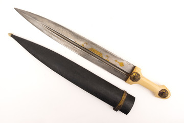 Oriental dagger with a handle from a bone sheath on a white background.