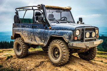 dirty SUV on blue sky background