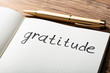 Gratitude Word With Pen On Notebook