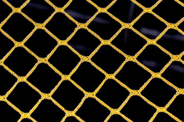 yellow mesh of rope on a black background