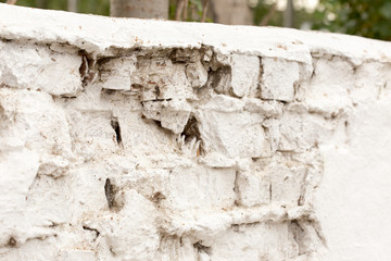 Background of old vintage dirty brick wall with peeling plaster, texture