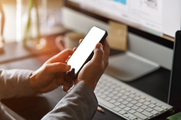 Businessman using mobile phone on desk, Smart phone showing blank screen for montage.