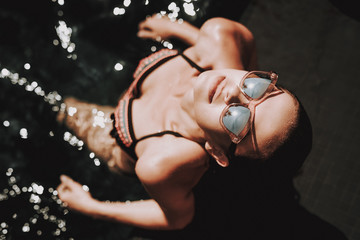 Wall Mural - Portrait of Young Smiling Woman Relaxing in Pool