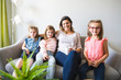 © Louis-Paul Photo - mother and daughters on sofa at home