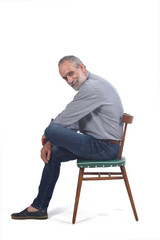 Wall Mural - portrait of middle aged man sitting  on white