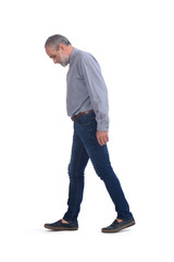 Wall Mural - middle-aged man with blue jeans and shirt on white background