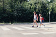 © Photographee.eu - Girl and boy with backpacks walking on pedestrian crossing from the school