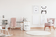 Stylish Scandinavian Nursery With White Furniture And Pink Accents, Cute Poster On The White Empty Wall With Copy Space