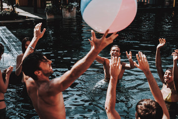 Wall Mural - Group of Young Smiling Friends having Fun in Pool