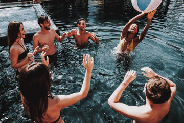 Wall Mural - Group of Young Smiling Friends having Fun in Pool