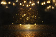 © tomertu - glitter vintage lights background. black and gold. de-focused