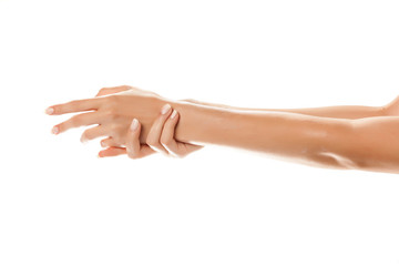 closeup of female hands applying hand cream on white background