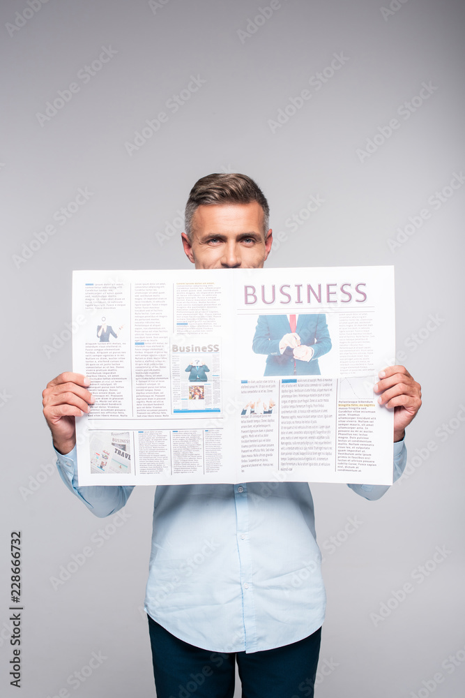 handsome adult businessman covering face with business newspaper ...